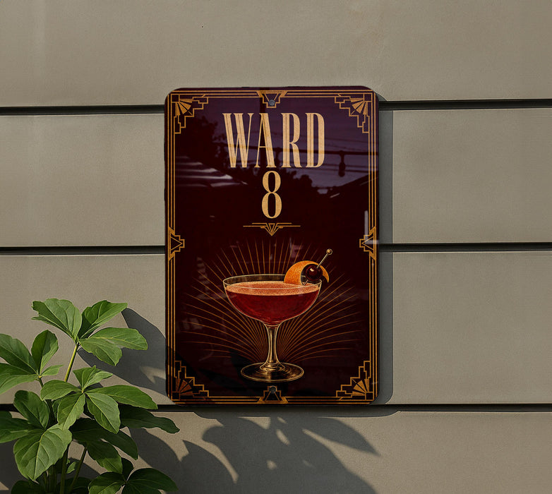 A sign for "Ward 8" featuring an illustration of a cocktail glass with an orange garnish.