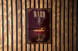 A sign with the number "8" and an illustration of a cocktail is displayed on a wooden wall.
