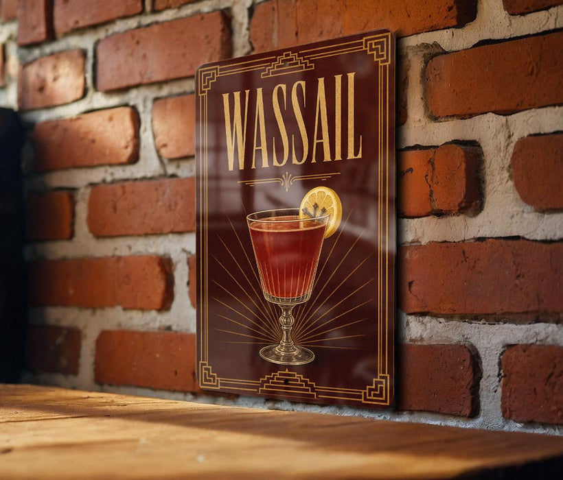 A framed poster of a red cocktail with a lemon slice, displayed on a brick wall.