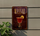 A sign for "Wassail" cocktail is displayed on a wall, featuring a glass of red cocktail with a lemon slice.