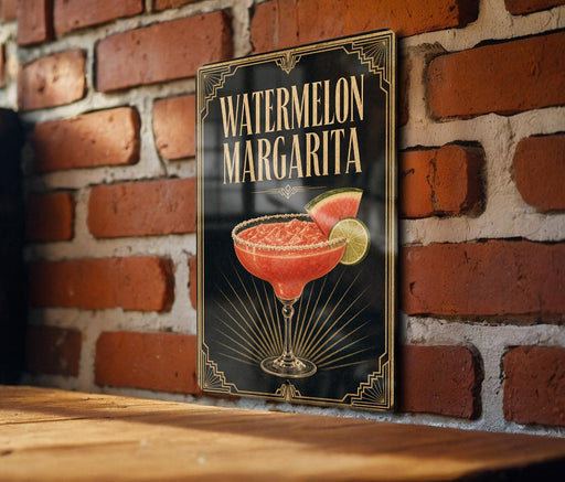 A sign for a "Watermelon Margarita" cocktail is displayed on a brick wall.
