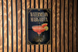 A poster for a "Watermelon Margarita" cocktail is displayed on a wooden wall.