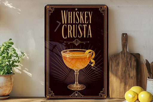 a decorative sign with the text "Whiskey Crusta" and an illustration of a glass of whiskey with a lemon twist.