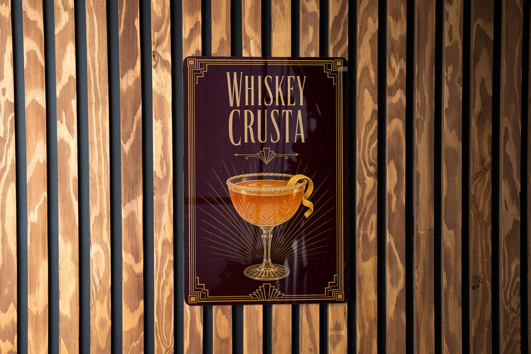 A poster with the title "Whiskey Crusta" displayed prominently, featuring an illustration of a glass filled with a golden-colored cocktail.