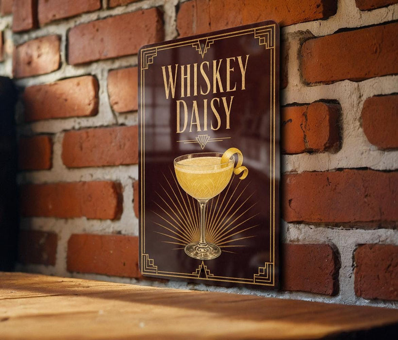 A sign with the text "Whiskey Daisy" and an illustration of a cocktail glass is displayed on a brick wall.