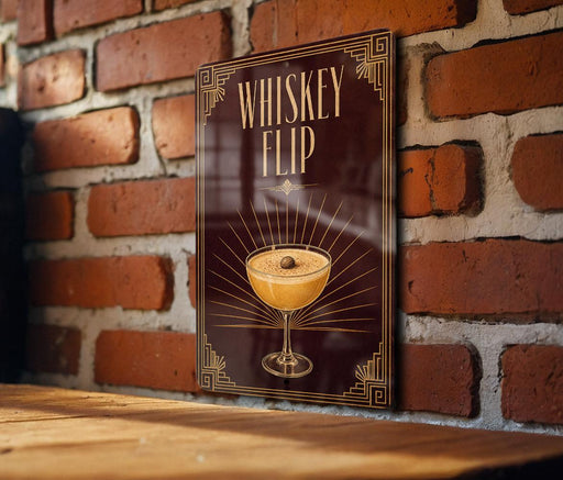 A poster or sign with the text "WHISKEY FLIP" and an illustration of a cocktail in a glass, mounted on a brick wall.
