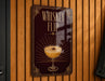 A sign that reads "Whiskey Flip" is hanging on a wooden wall.