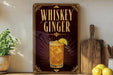 A decorative sign for whiskey ginger, featuring an illustration of a glass of whiskey with a slice of lemon on the rim.