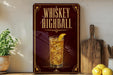 A red sign with gold lettering advertising "Whiskey Highball" is displayed on a wooden shelf, accompanied by a glass of whiskey, a lemon, and a wooden cutting board.