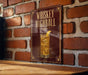 A poster or sign with the text "WHISKEY HIGHBALL" and an illustration of a cocktail with ice cubes.
