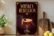 A decorative sign with the text "WHISKEY REBELION" and an illustration of a cocktail on a wooden surface.