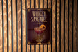 A sign for whiskey sangaree is displayed on a wooden wall.