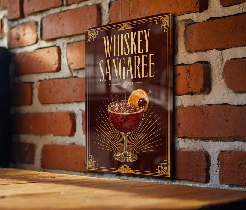 A sign for whiskey Sangaree is displayed on a brick wall, featuring an illustration of a glass containing a red-colored drink with a cherry on top.