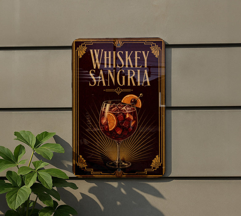A sign for whiskey-sangria cocktail is displayed on a wall, featuring a glass of the cocktail with orange slices and a decorative border.