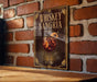 A sign for whiskey-sangria cocktail is displayed on a brick wall.