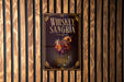 A sign for whiskey-sangria cocktail is displayed on a wooden wall.