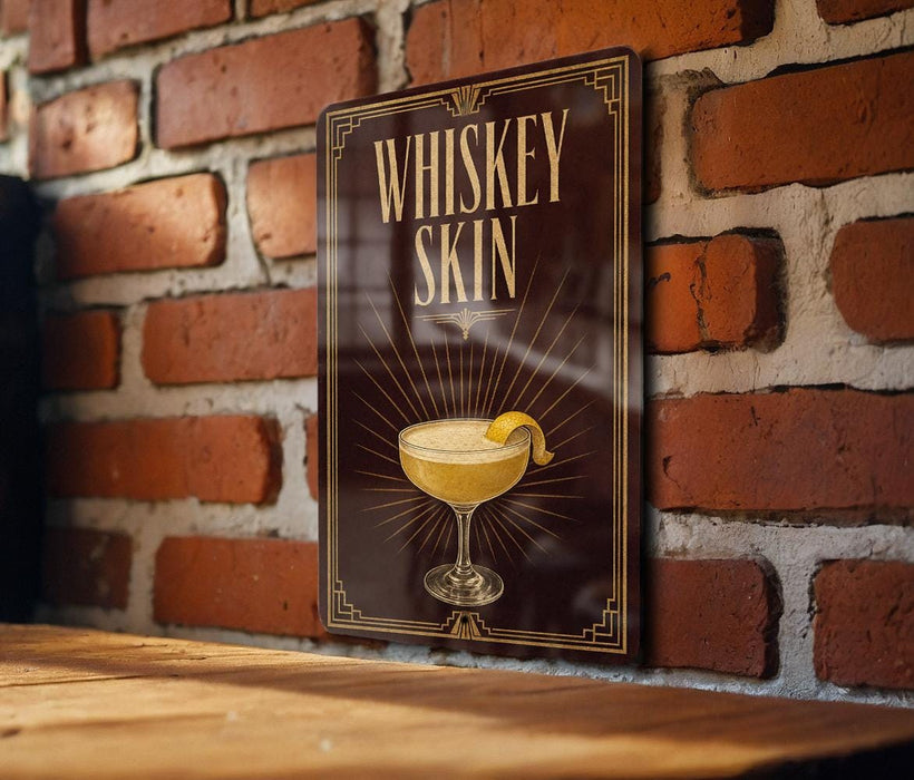 A sign with the text "WHISKEY SKIN" and an illustration of a cocktail glass with a lemon peel.