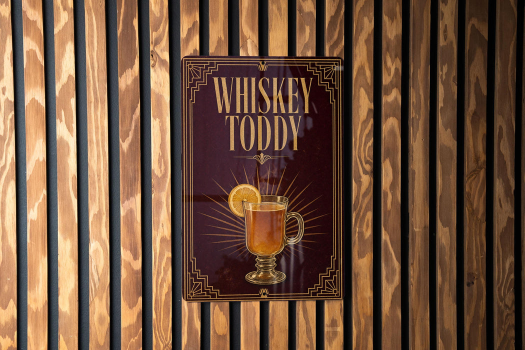 A poster advertising whiskey toody, featuring a glass of whiskey with a lemon slice.
