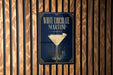 A sign for a white chocolate martini is displayed on a wooden wall.