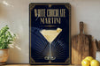 A framed poster advertising a "White Chocolate Martini" is displayed on a wall, with a glass martini and lemon on the poster.
