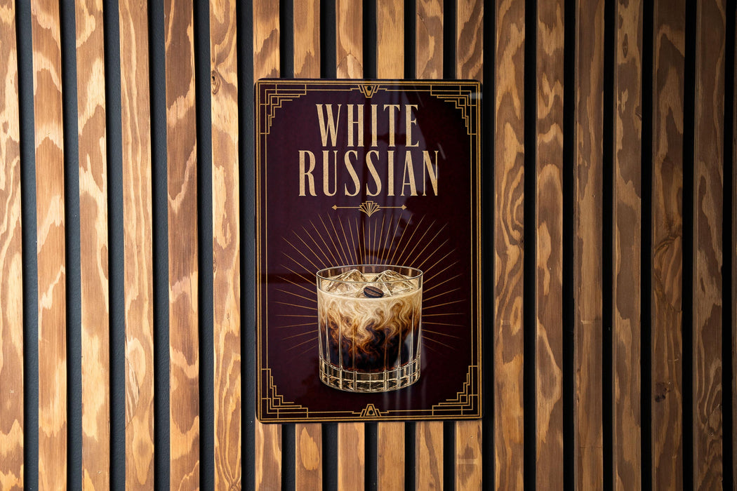 a poster advertising a drink called "White Russian" with a glass of the drink and ice cubes.