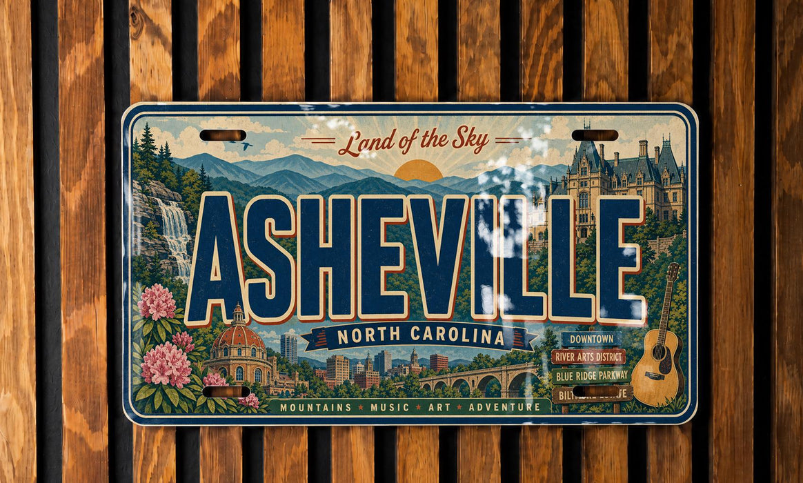 The image is a vintage license plate from North Carolina that features the city of Asheville, with a scenic mountain landscape and a castle in the background.