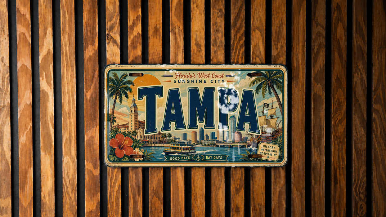 A vintage license plate from Florida's West Coast, specifically Tampa, with a tropical cityscape and palm trees on it, mounted on a wooden wall.