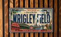 A vintage Chicago Cubs baseball plate with the text "Chicago Home of the Cubs" and "WRIGLEY FIELD" prominently displayed.