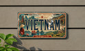 a vintage license plate from Vietnam with a scenic illustration of the country's landscape and culture.
