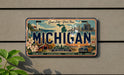 A vintage Michigan license plate with a scenic background depicting the state's natural and urban landscapes.