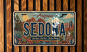 A vintage Arizona license plate with a desert landscape design, featuring the word "SEDONA" prominently displayed.