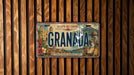 A vintage license plate from Granada, Spain, with a colorful illustration of the city's landmarks and natural scenery.