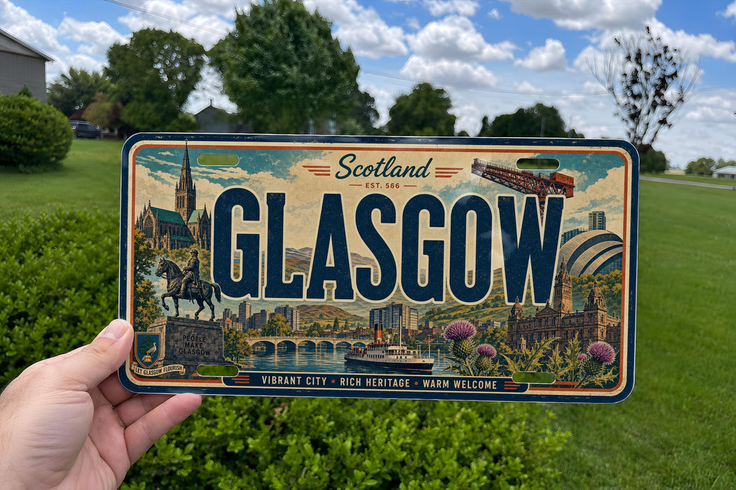 A person is holding a license plate with the word "GLASGOW" prominently displayed on it. The license plate also features illustrations of various landmarks and scenery, indicating that it is a decorative license plate from Scotland.