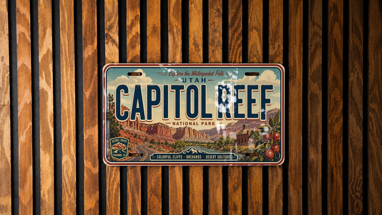 A vintage license plate from Utah, specifically the Capitol Reef National Park, is displayed against a wooden background.