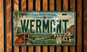 A vintage license plate from Vermont with a scenic countryside illustration.