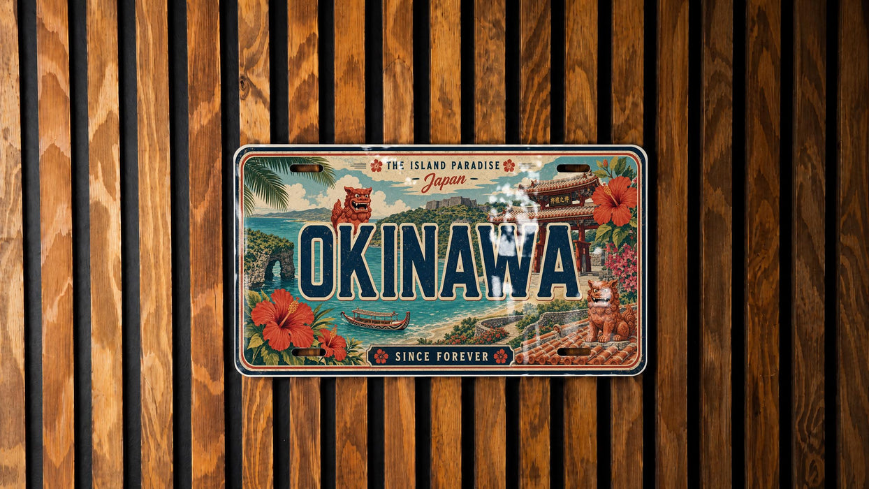 A vintage license plate from Japan with the text "OKINAWA" prominently displayed, along with various scenic elements such as a temple, ocean, and flowers.