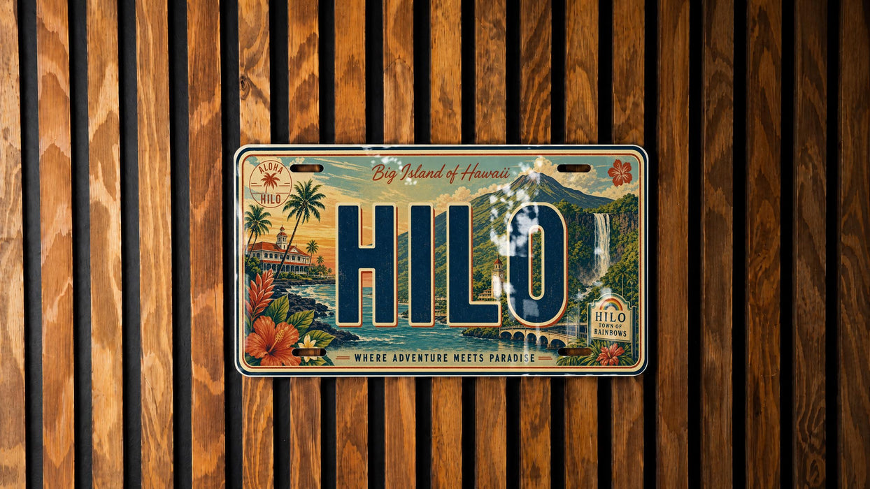 A license plate with the word "HILO" prominently displayed, featuring a tropical island landscape with palm trees, mountains, and a body of water.
