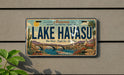 A vintage license plate from Arizona, featuring a scenic illustration of Lake Havasu with a bridge, palm trees, and a body of water.