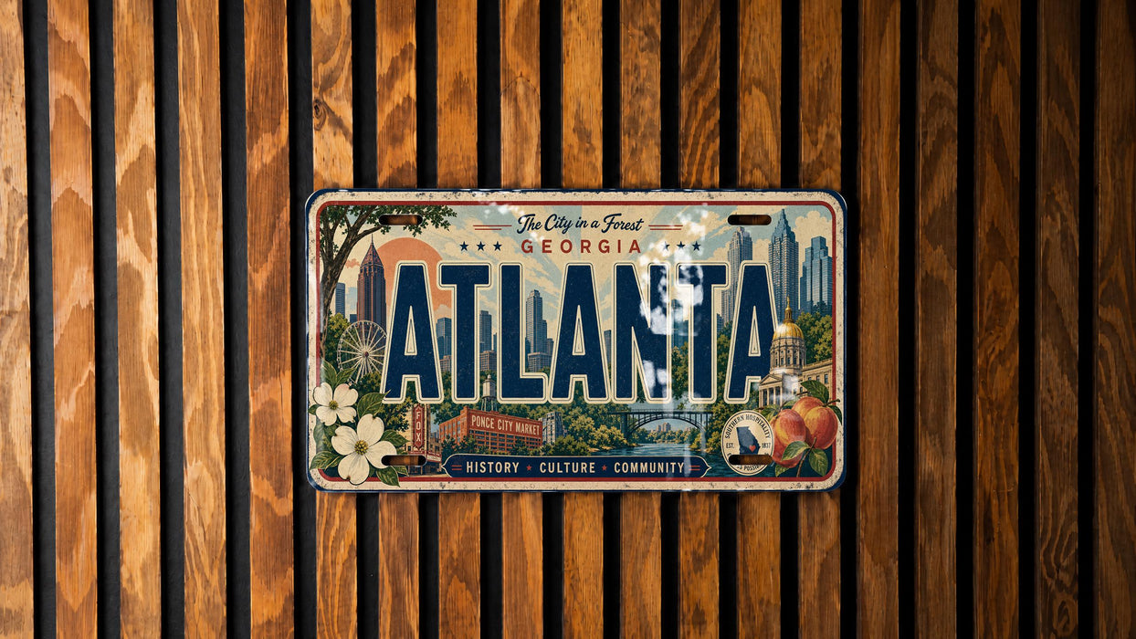 A decorative license plate from Georgia, featuring the city's skyline and landmarks, is displayed on a wooden wall.