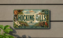 A vintage license plate with a scenic mountain landscape and the text "HOCKING HILLS" is displayed on a wall.