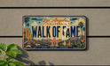 A vintage California license plate with the text "WALK OF FAME" and a cityscape design, mounted on a wall.