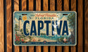 A vintage license plate from Florida that reads "CAPITA" with a tropical beach scene and lighthouse in the background.