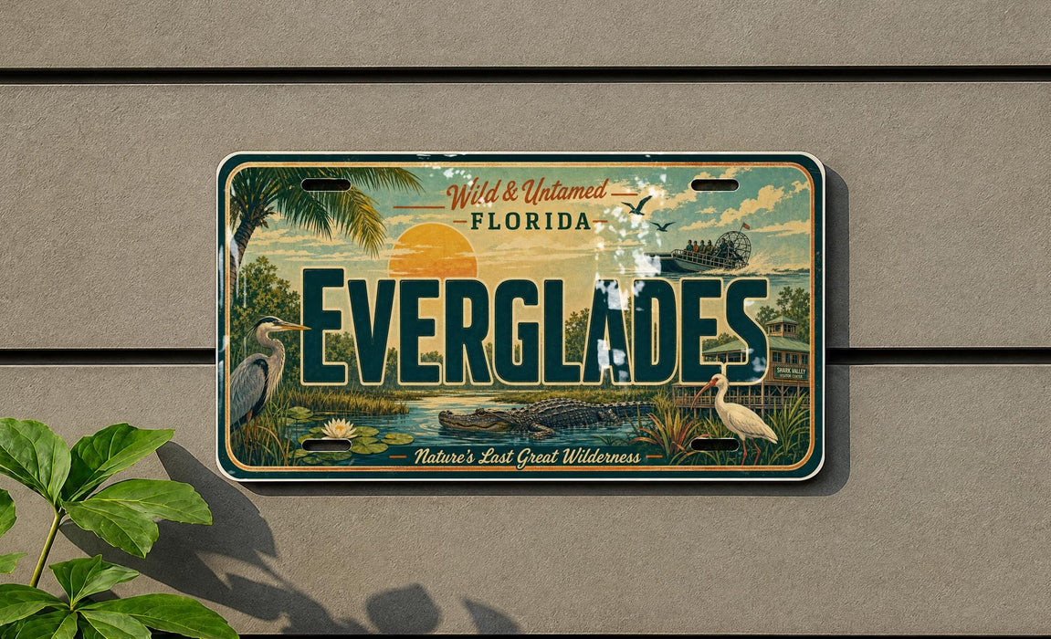 A license plate with the text "EVERGLADES" and "Wild & Untamed Florida" printed on it, along with an illustration of a bird, palm tree, and other natural elements.