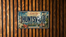 A vintage license plate from Alabama, with the text "ROCKET CITY ALABAMA" and "HUNTSVILLE" prominently displayed.