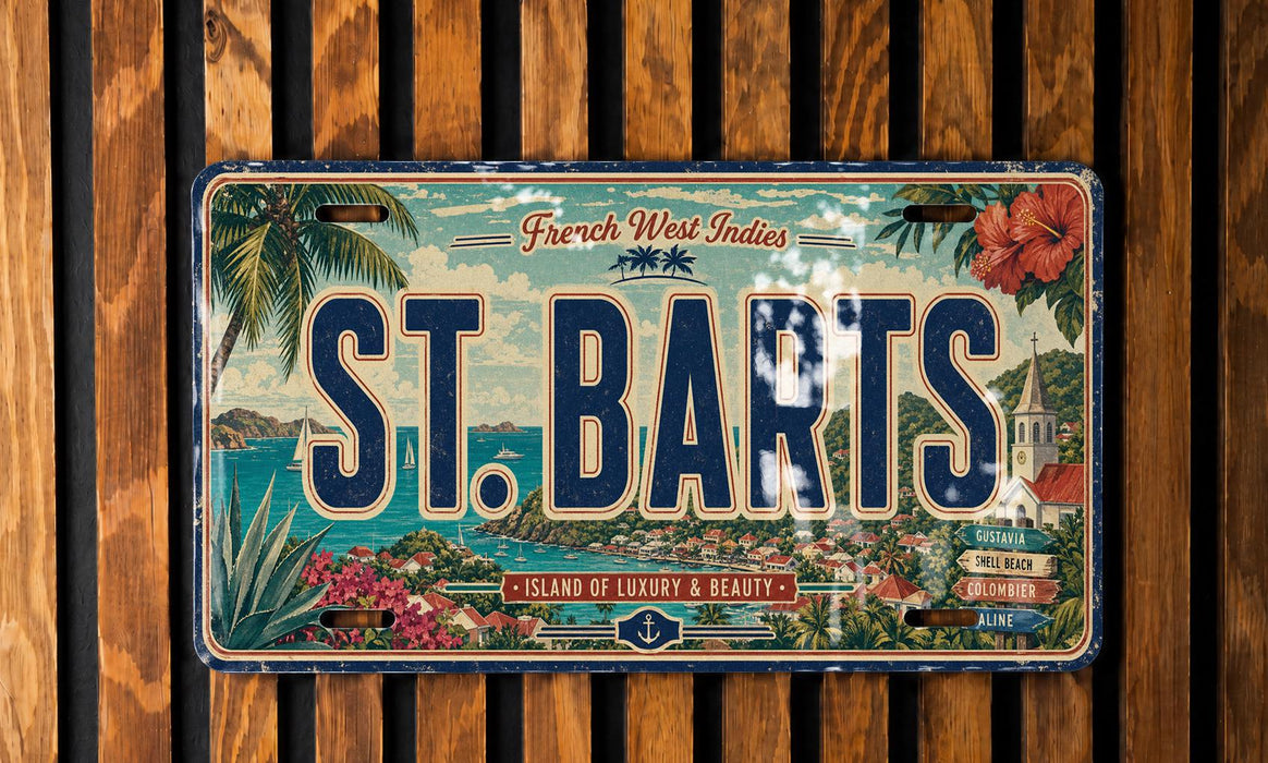 A vintage license plate from St. Barts, featuring a tropical island scene with palm trees, flowers, and a body of water.