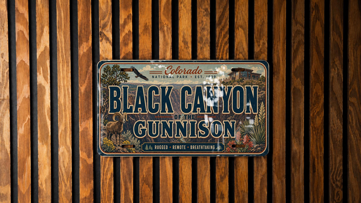 A metal sign with the text "Black Canyon of the Gunnison" is displayed against a wooden background.