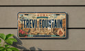 a license plate with the text "TREVI FOUNTAIN" and a decorative illustration of the Trevi Fountain in Rome, Italy.