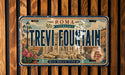A vintage license plate from Italy with the text "TREVI FOUNTAIN" and a decorative image of the Trevi Fountain.