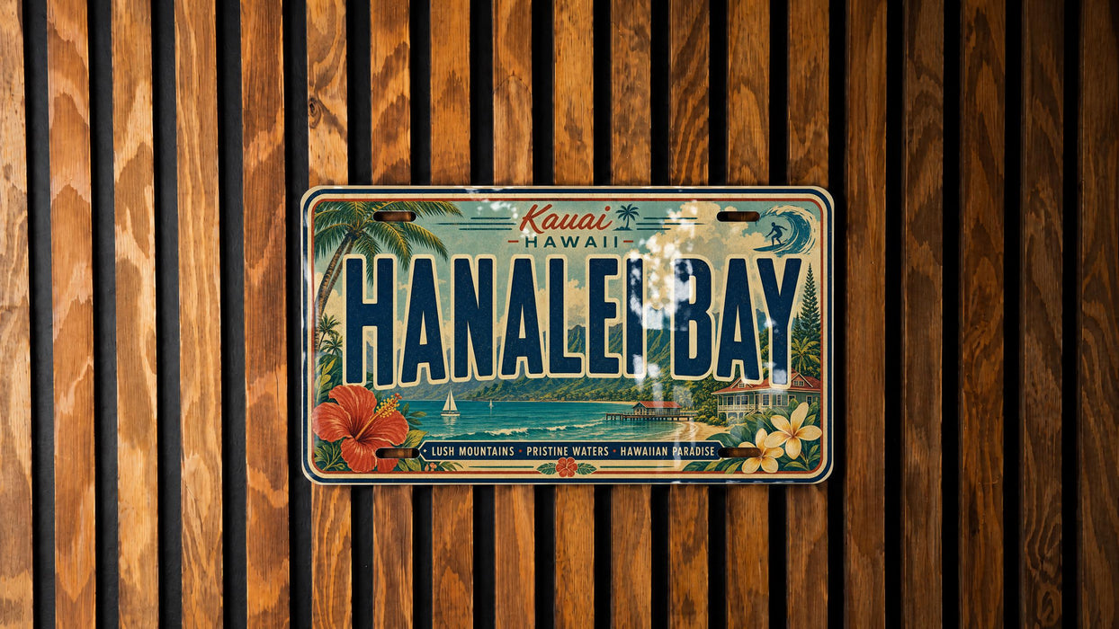 A vintage license plate from Hawaii, with the text "Kauai Hanaal Bay" printed on it, is displayed on a wooden wall.