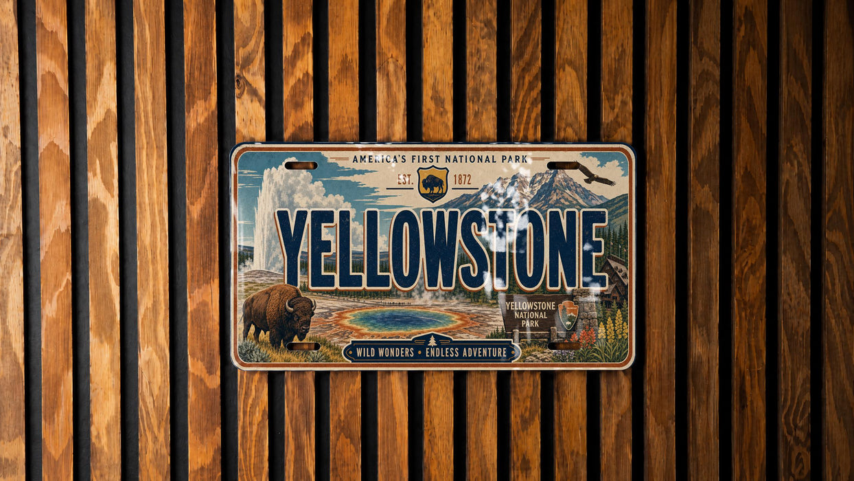 A license plate with the text "Yellowstone" and an illustration of a buffalo and a geyser, mounted on a wooden wall.